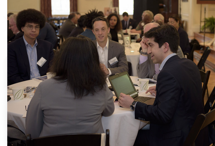attendees of a meeting sitting at a table