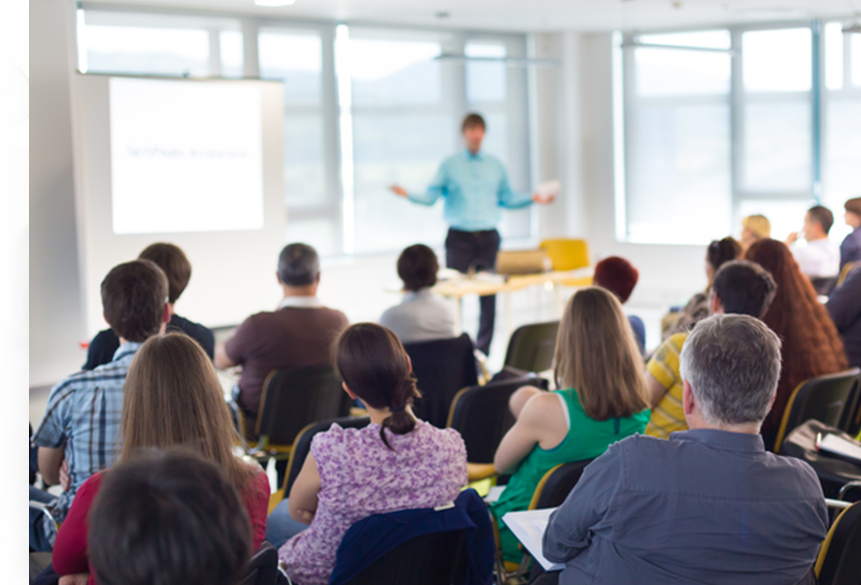 man speaking to group in a room