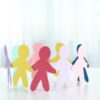 Colorful paper people cut outs holding hands in a circle